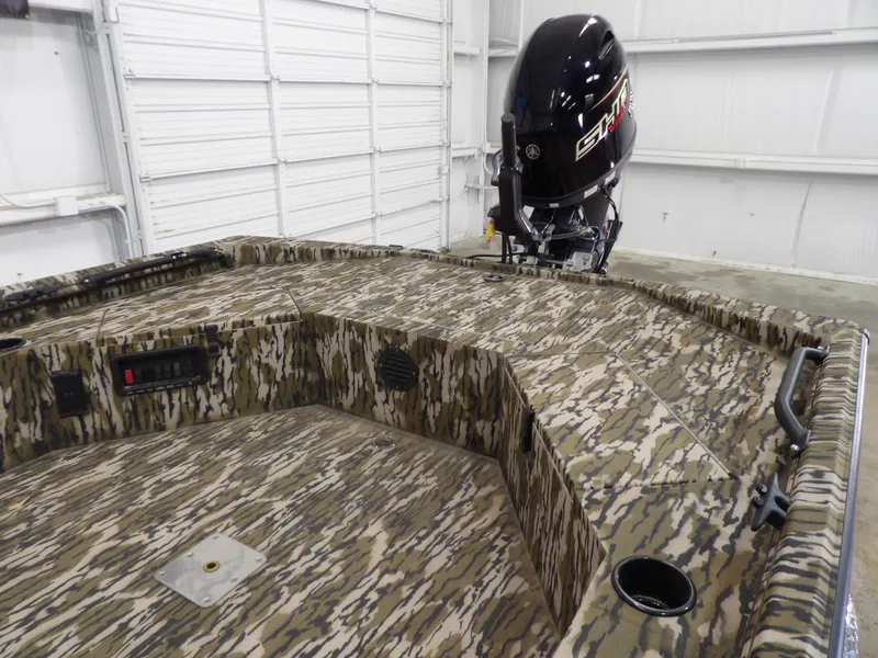 Slide: The Image of 2025 Avid 18 Commander boat with camouflage design and powerful outboard motor. - 14