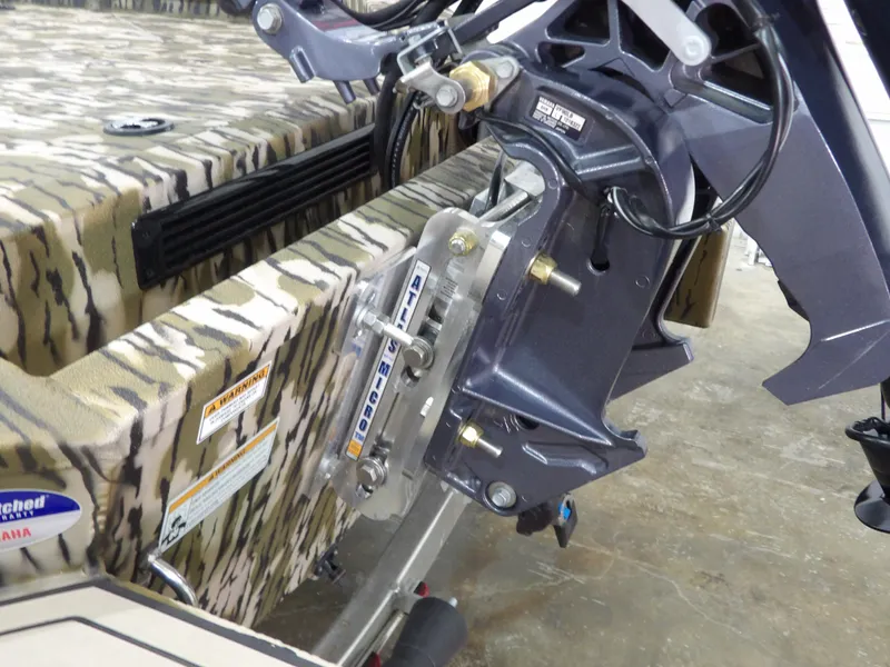 Slide: The Image of 2025 Avid 18 Commander boat with camo design and Yamaha engine mount detail. - 17