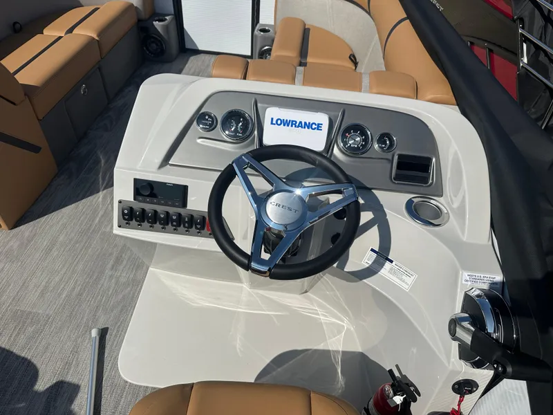 Slide: The Image of 2024 Crest Classic LX 220 SLSC boat dashboard with Lowrance system and tan seating. - 6