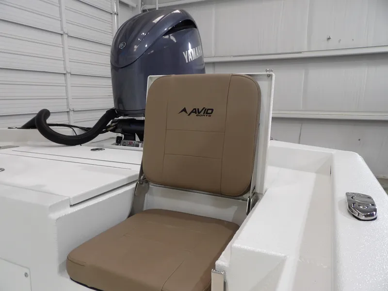 Slide: The Image of Avid 21FST 2025 boat seat with Yamaha engine in a garage setting. - 10