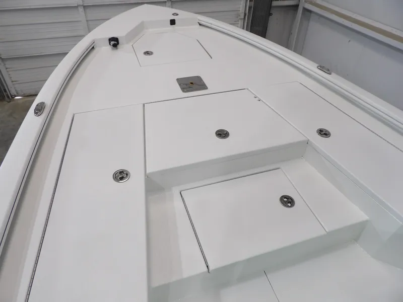 Slide: The Image of Avid 21FST 2025 boat deck with storage compartments in a garage setting. - 11