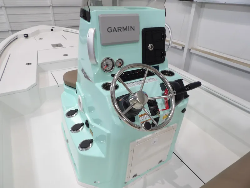 Slide: The Image of Avid 21FST 2025 boat console with Garmin navigation, steering wheel, and gauges. - 15