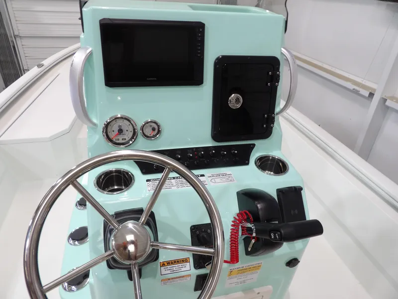 Slide: The Image of Avid 21FST 2025 boat dashboard with steering wheel, gauges, and controls. - 17