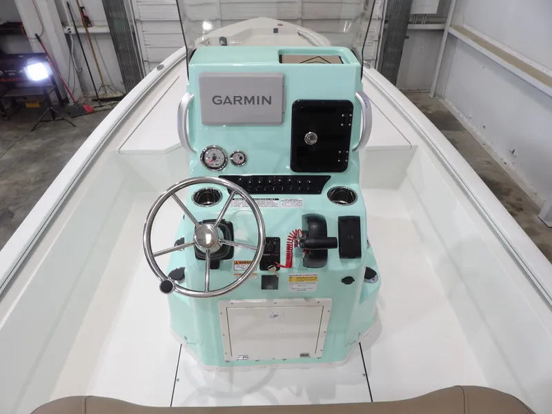 Slide: The Image of 2025 Avid 21FST boat console with Garmin navigation, steering wheel, and controls. - 18