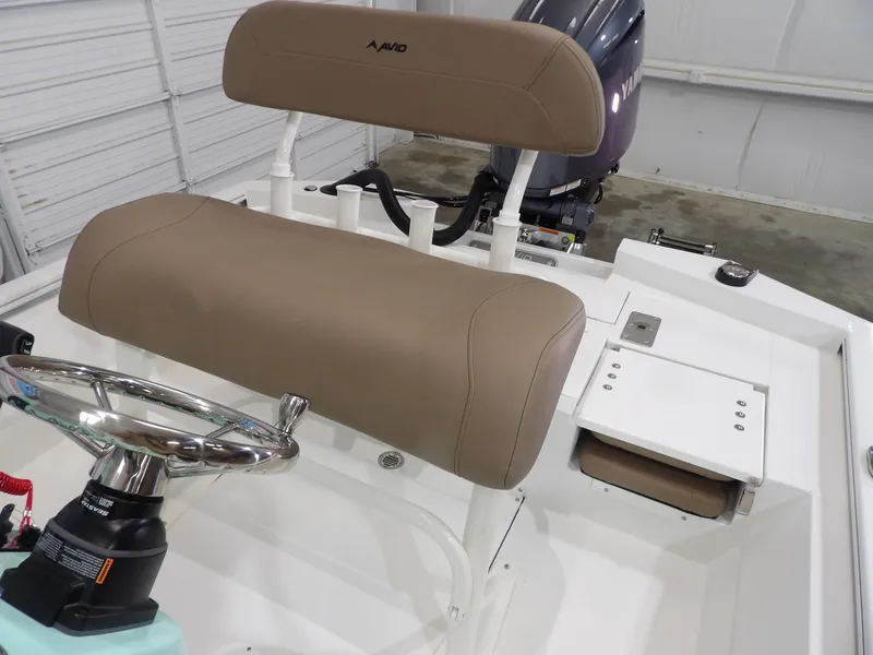Slide: The Image of Avid 21FST 2025 boat interior with tan seating and steering wheel. - 19