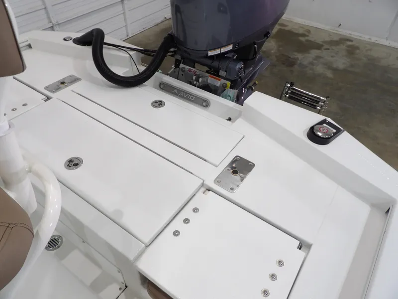 Slide: The Image of Avid 21FST 2025 boat deck with motor, featuring sleek white design and storage compartments. - 20