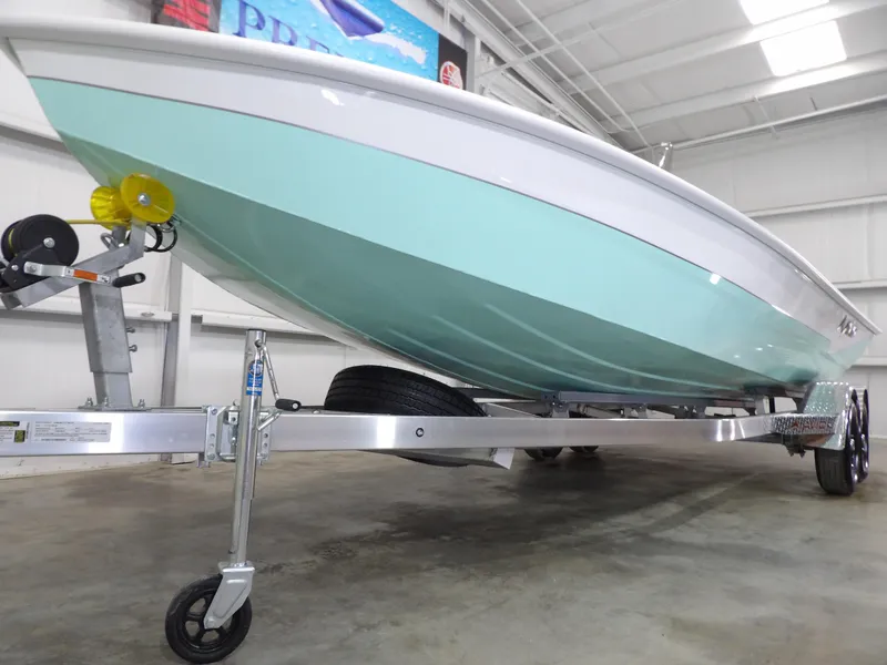 Slide: The Image of 2025 Avid 21FST boat on trailer in indoor showroom. - 5