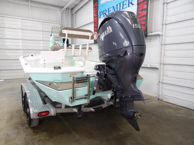 Slide: The Image of 2025 Avid 21FST boat with Yamaha 150 engine on trailer in garage. - 7