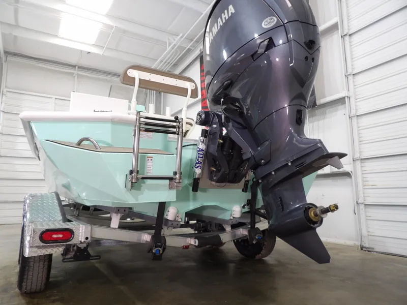 Slide: The Image of 2025 Avid 21FST boat with Yamaha outboard motor on trailer in a garage. - 8