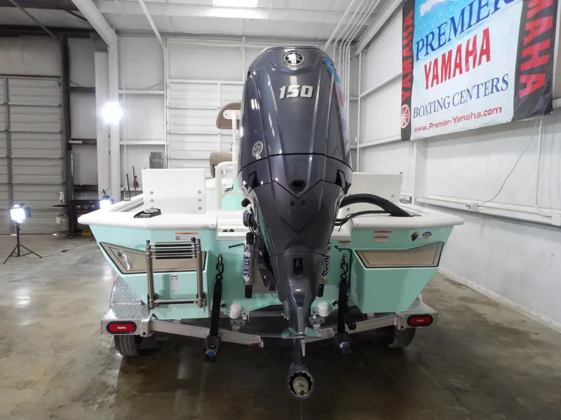 Slide: The Image of Avid 21FST 2025 boat with Yamaha 150 engine in showroom. - 9