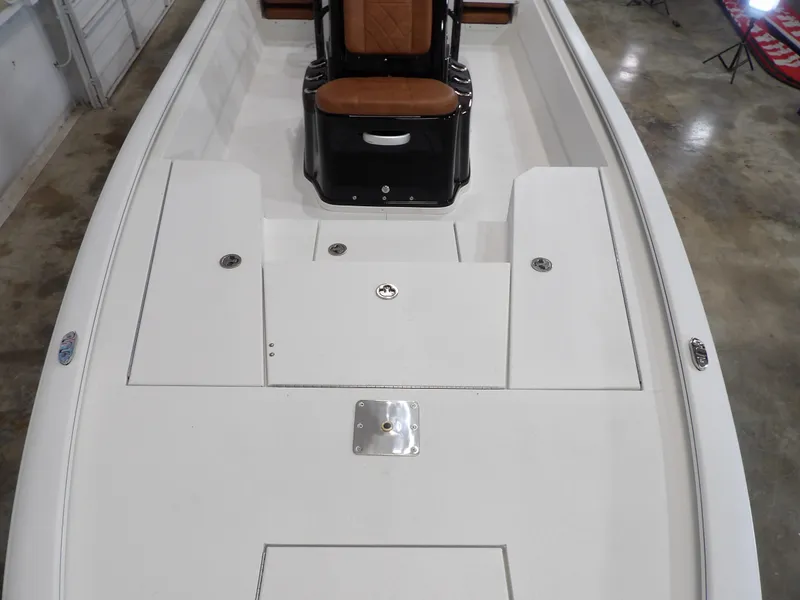 Slide: The Image of Avid 21FST 2025 boat interior with white deck and brown seating. - 10