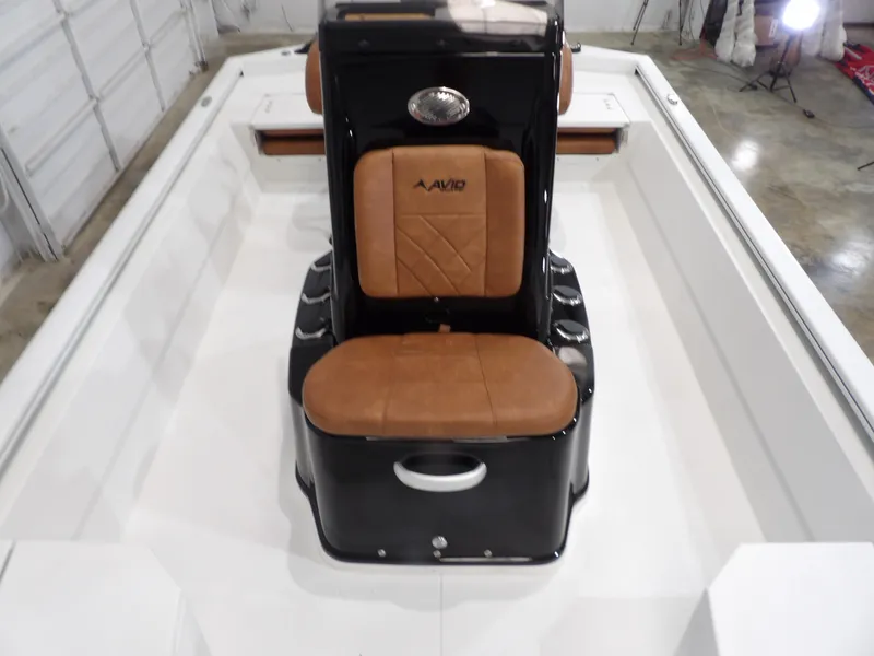 Slide: The Image of 2025 Avid 21FST boat interior with tan seating and sleek black console. - 12