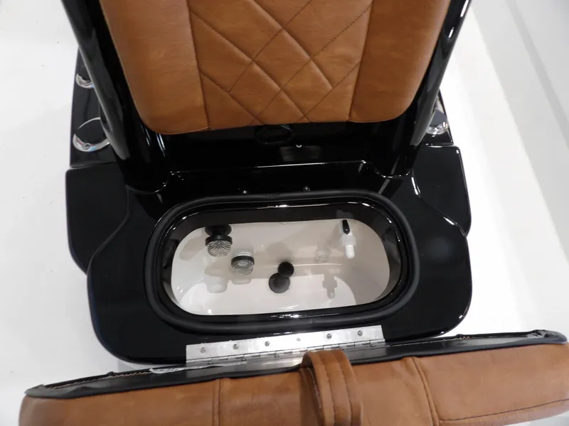 Slide: The Image of Avid 21FST 2025 boat seat with storage compartment, featuring brown leather upholstery. - 14