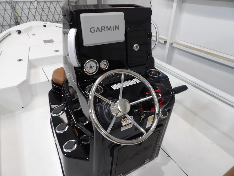 Slide: The Image of Avid 21FST 2025 boat console with Garmin navigation and steering wheel. - 15
