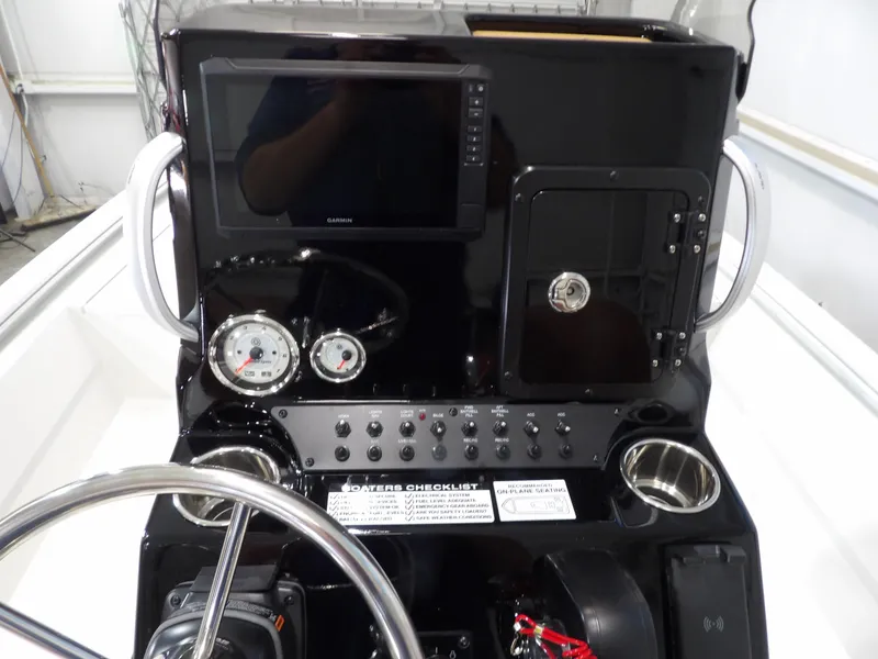 Slide: The Image of Avid 21FST 2025 boat console with Garmin display, gauges, and controls. - 16