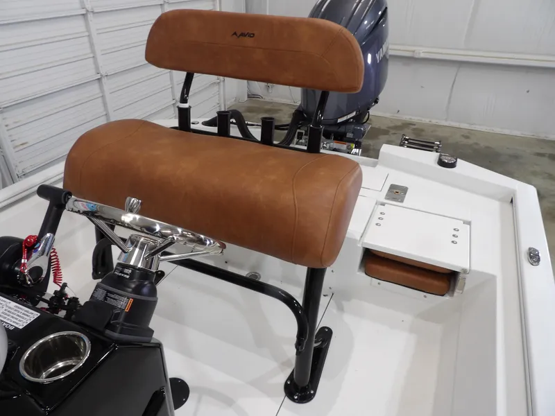 Slide: The Image of 2025 Avid 21FST boat interior with brown leather seating and steering console. - 17