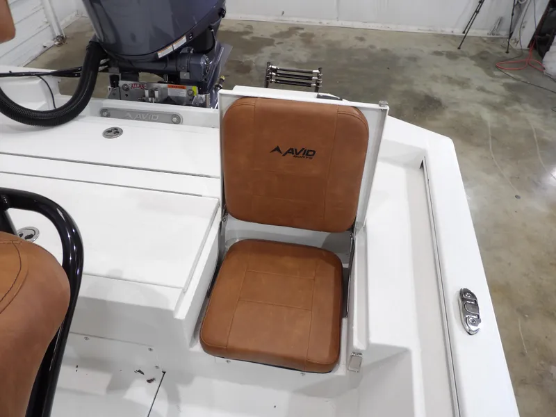 Slide: The Image of Brown leather seat on 2025 Avid 21FST boat, featuring sleek design and modern engine. - 21