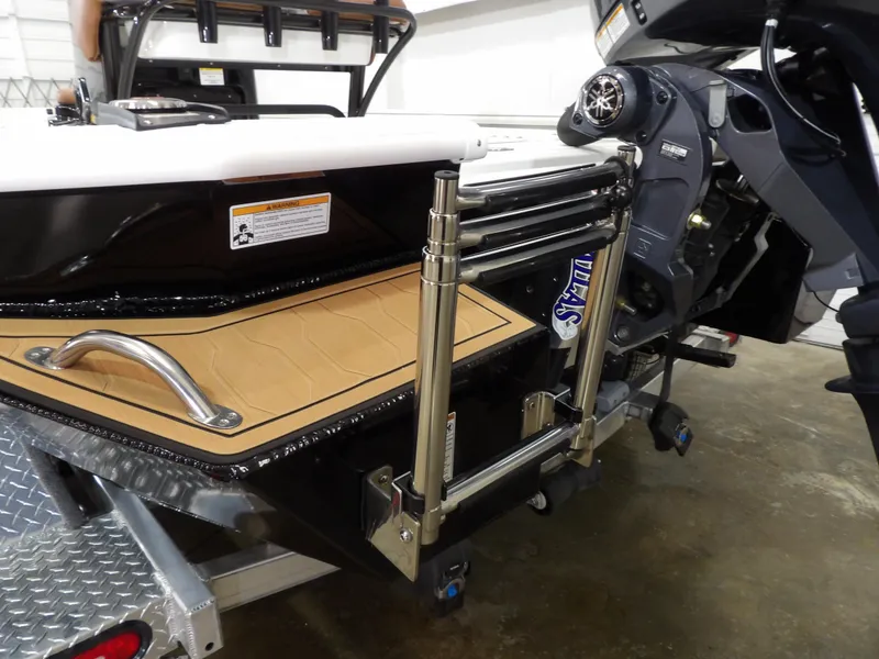 Slide: The Image of Avid 21FST 2025 boat with stainless steel ladder and motor, on a trailer. - 24