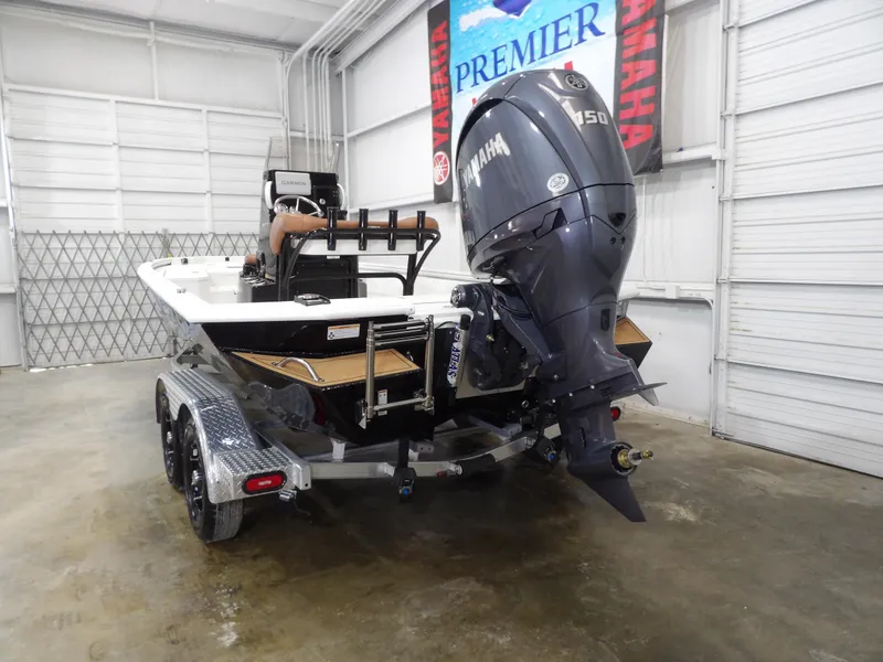 Slide: The Image of 2025 Avid 21FST boat with Yamaha 150 engine on trailer in garage. - 6