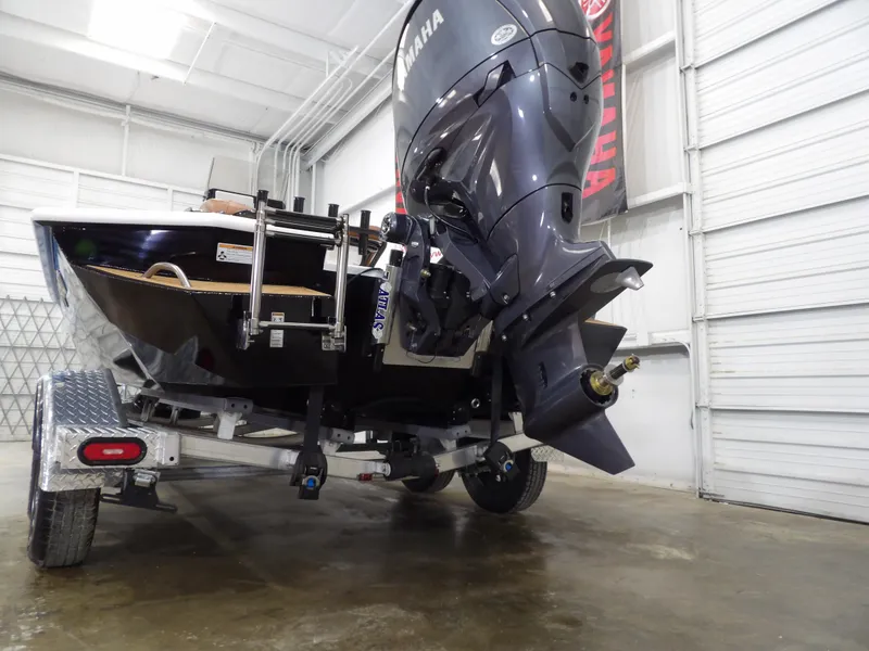 Slide: The Image of 2025 Avid 21FST boat with Yamaha outboard motor on a trailer in a garage. - 7
