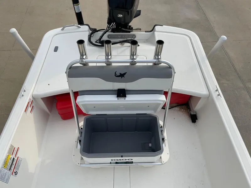 Slide: The Image of 2020 Mako Pro Skiff 17 boat interior with open cooler and rod holders. - 10