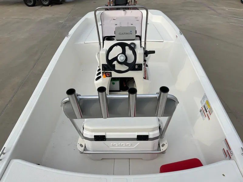 Slide: The Image of 2020 Mako Pro Skiff 17 boat interior with steering console and rod holders. - 11