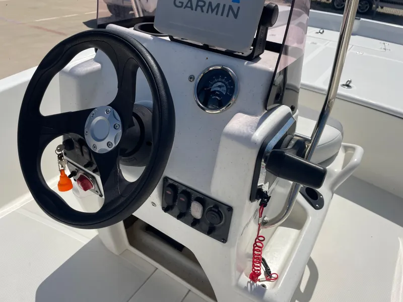 Slide: The Image of 2020 Mako Pro Skiff 17 boat console with steering wheel and Garmin navigation system. - 13