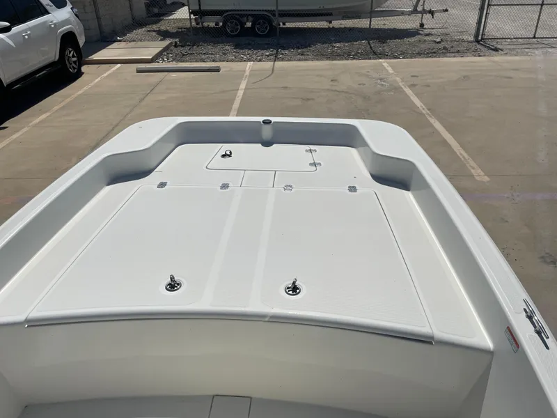 Slide: The Image of 2020 Mako Pro Skiff 17 boat deck in a parking lot. - 16