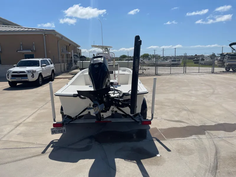 Slide: The Image of 2020 Mako Pro Skiff 17 boat on trailer in sunny parking lot. - 6