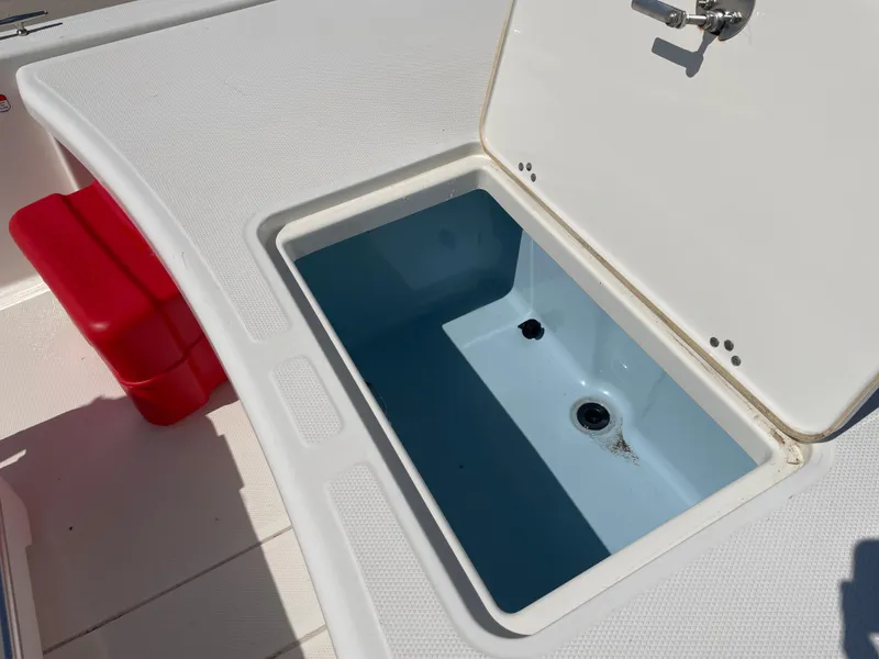 Slide: The Image of Open storage compartment on 2020 Mako Pro Skiff 17 boat deck. - 8