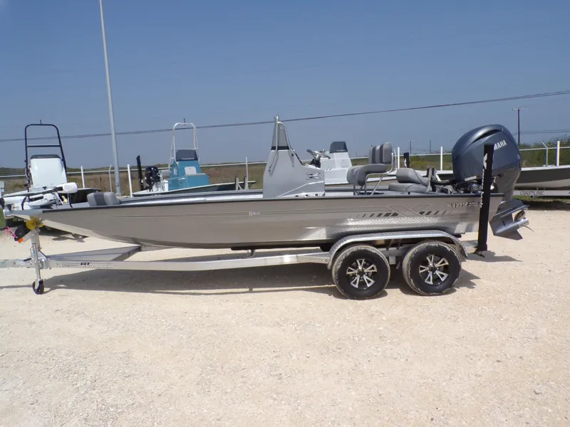 Slide: The Image of 2025 Xpress H210BAY boat on trailer, featuring sleek design and Yamaha engine. - 1