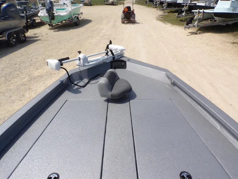 Slide: The Image of 2025 Xpress H210BAY boat with trolling motor and seat, parked on gravel lot. - 15