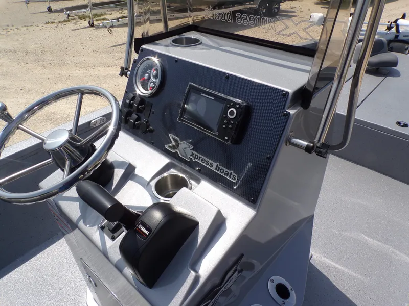 Slide: The Image of 2025 Xpress H210BAY boat console with steering wheel and navigation controls. - 28