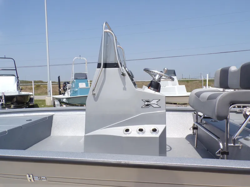Slide: The Image of 2025 Xpress H210BAY boat with sleek console and seating, displayed outdoors. - 30