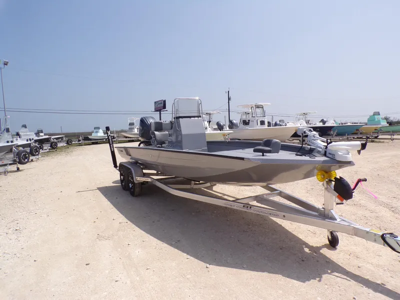 Slide: The Image of 2025 Xpress H210BAY boat on trailer in outdoor dealership lot. - 7
