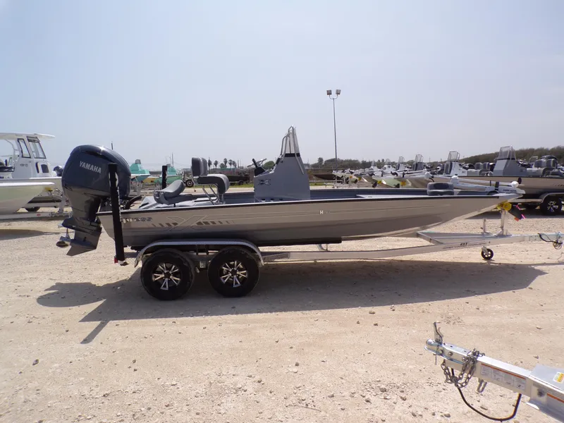 Slide: The Image of 2025 Xpress H210BAY boat on trailer with Yamaha outboard motor, parked outdoors. - 8