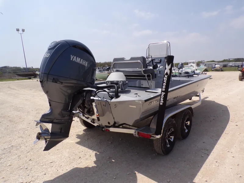 Slide: The Image of 2025 Xpress H210BAY boat with Yamaha engine on a trailer in a sunny outdoor setting. - 9