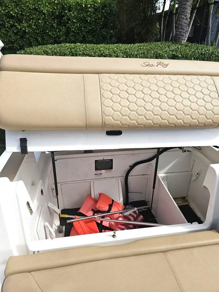 Slide: The Image of 2018 Sea Ray SDX 290 Outboard boat storage compartment with life jackets and equipment. - 13
