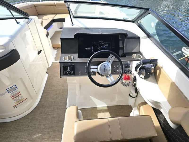 Slide: The Image of 2018 Sea Ray SDX 290 Outboard boat cockpit with steering wheel and controls. - 15