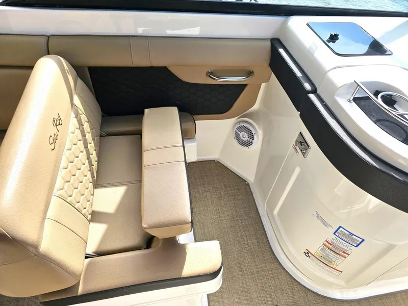 Slide: The Image of 2018 Sea Ray SDX 290 Outboard interior with tan seating and modern design. - 16