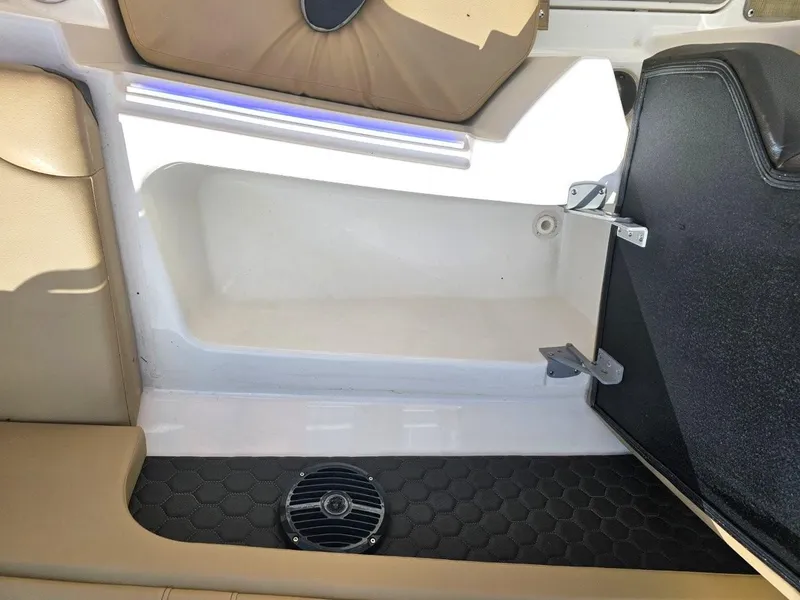 Slide: The Image of 2018 Sea Ray SDX 290 Outboard interior, featuring seating and storage area with speaker. - 17