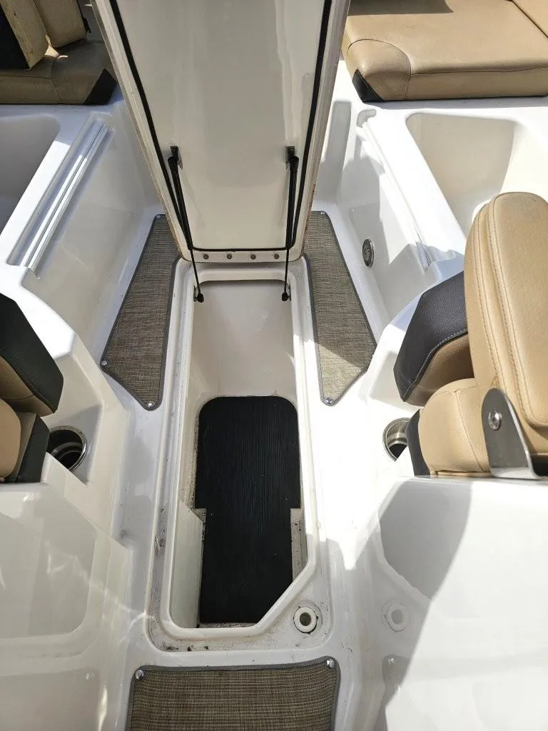 Slide: The Image of 2018 Sea Ray SDX 290 Outboard interior with open storage compartment and seating. - 19