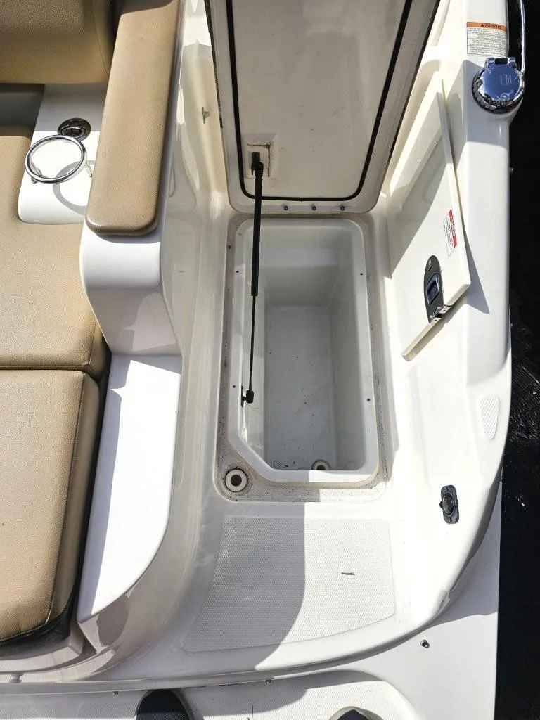 Slide: The Image of 2018 Sea Ray SDX 290 Outboard boat storage compartment with beige seating. - 21