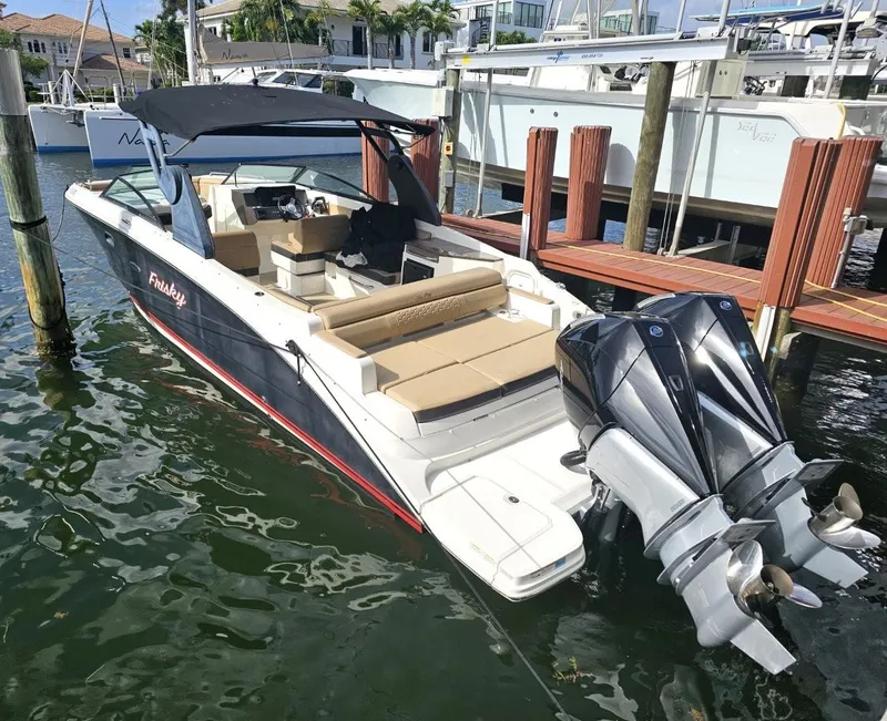 Slide: The Image of 2018 Sea Ray SDX 290 Outboard boat docked, featuring dual engines and spacious seating. - 3