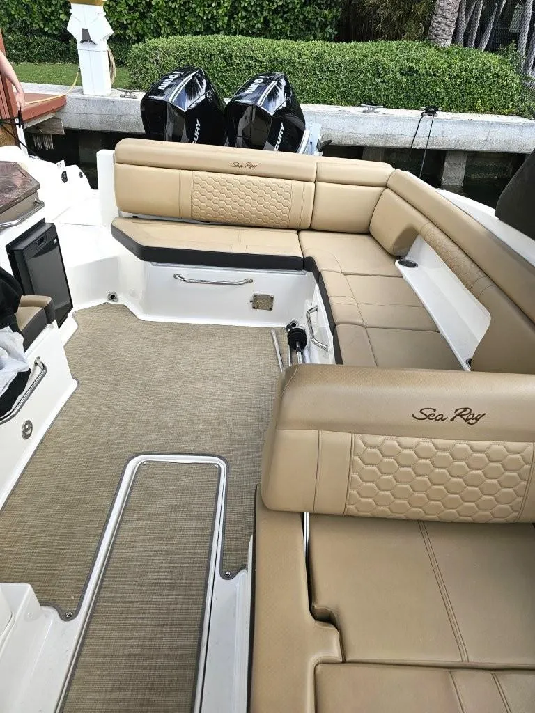 Slide: The Image of 2018 Sea Ray SDX 290 Outboard with beige seating and dual engines docked. - 7