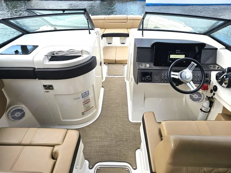 Slide: The Image of 2018 Sea Ray SDX 290 Outboard boat interior with beige seating and modern dashboard. - 8
