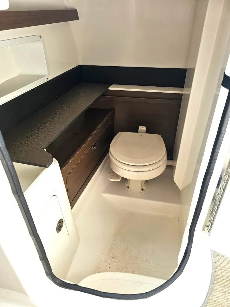 Slide: The Image of 2018 Sea Ray SDX 290 Outboard boat interior with compact bathroom and toilet. - 9