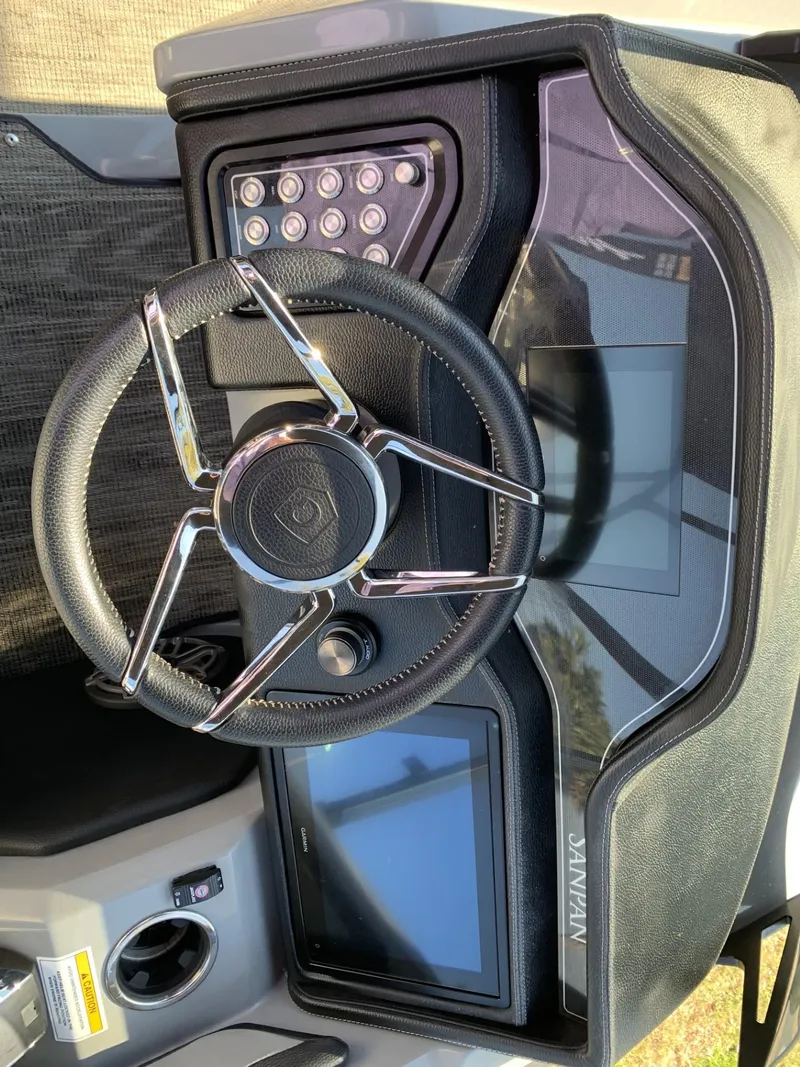 Slide: The Image of Steering console of 2023 Godfrey San Pan 2700 DFLC with modern controls and displays. - 6