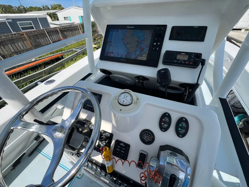 Slide: The Image of 2007 Young Boats Young 24 helm with navigation equipment and steering wheel. - 10