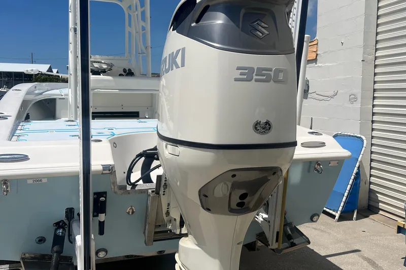 Slide: The Image of 2007 Young Boats Young 24 with Suzuki 350 outboard motor, docked outdoors. - 12